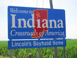 welcome to indiana sign in front of a corn field