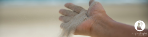 Outstretched hand with sand blowing away - Let it go