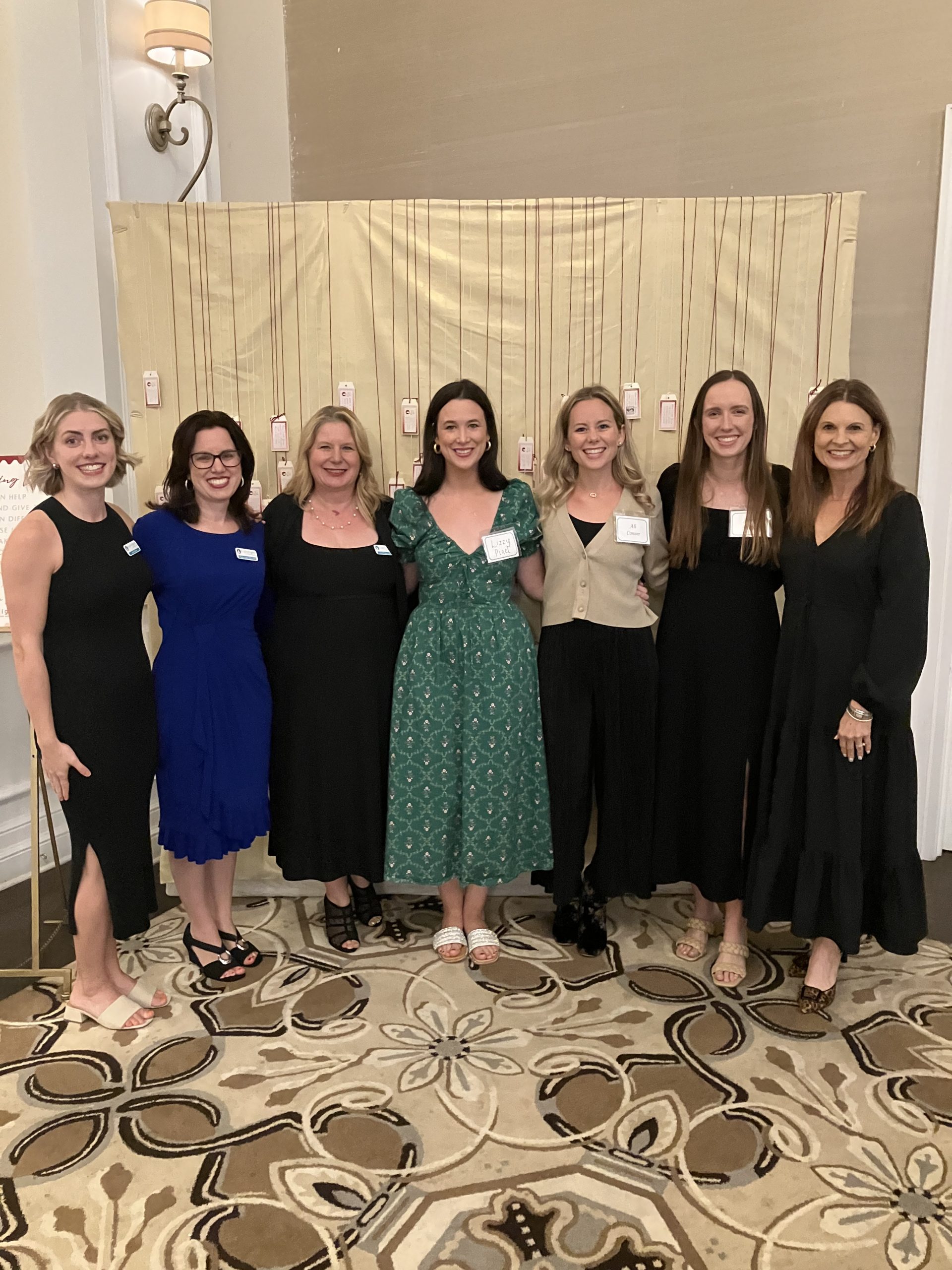 husband and wife with adopted child on a bridge